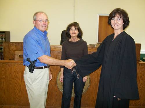 Larry Plott shaking hands with woman